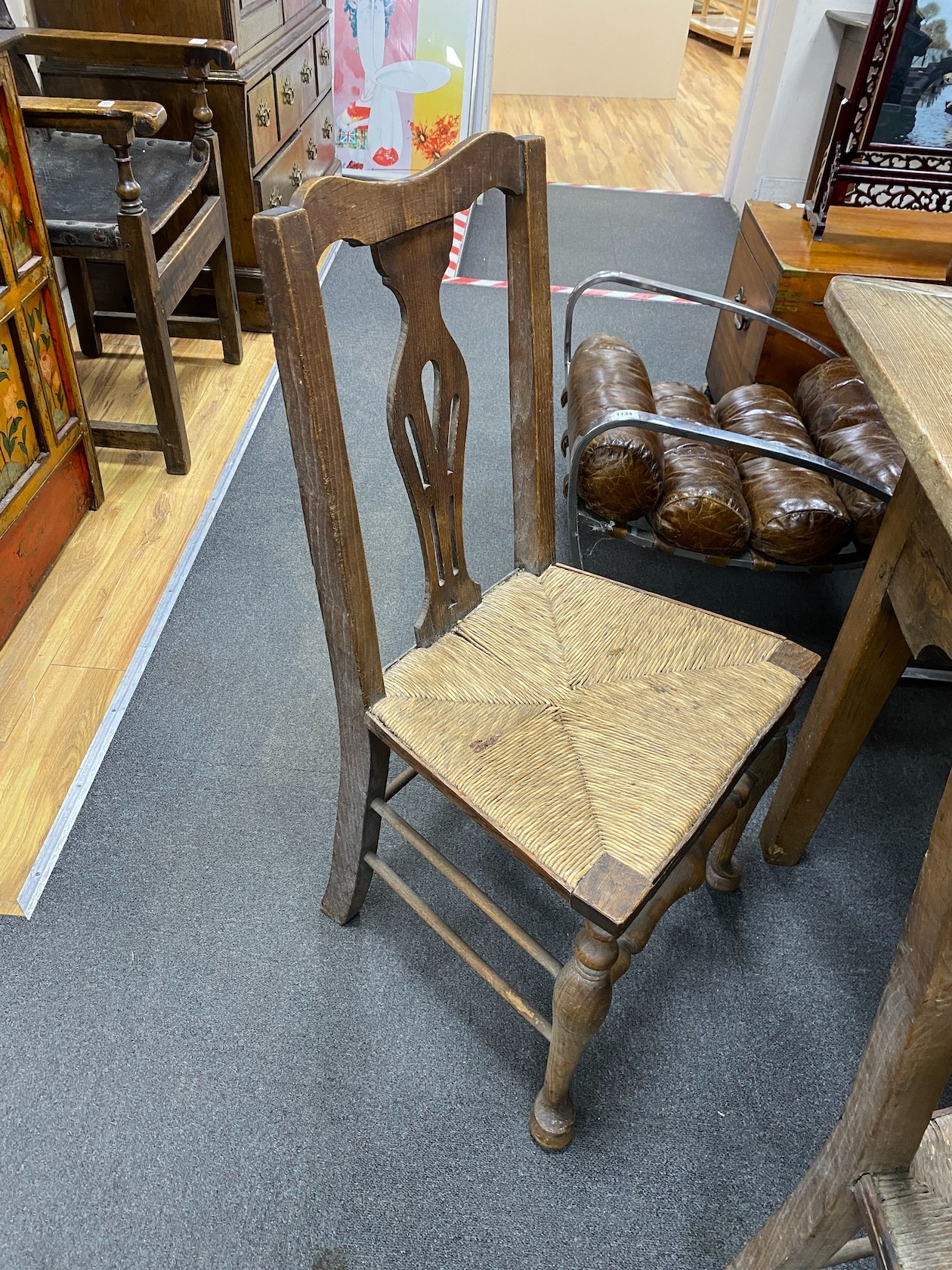 A 19th century elm plank topped kitchen dining table, on a beech underframe, the top, length 275cm, width 92cm, height 76cm, together with a set of ten oak and ask rush seated dining chairs (2 arm, 8 single)